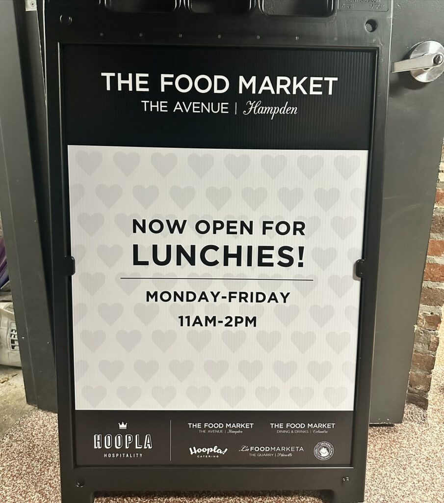 Food Market Hampden restaurant board on the street showing timings for lunch